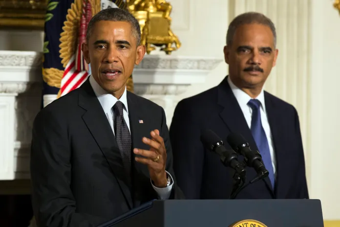 President Barack Obama, accompanied by Attorney General Eric Holder, speaks in the State Dining Room of the White House to announce Holder is resigning, on Thursday, Sept. 25, 2014, in Washington. Holder, who served as the public face of the Obama administration's legal fight against terrorism and weighed in on issues of racial fairness, is resigning after six years on the job. (AP Photo/Evan Vucci)