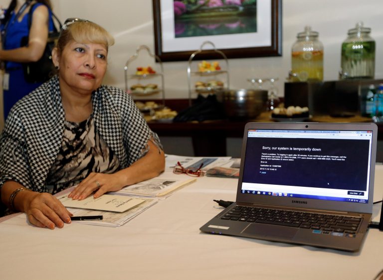 Yannette Castellano waits to talk to a navigator about health care options available under the Affordable Care Act, at the North Shore Medical Center, Tuesday, Nov. 19, 2013, in Miami. The computer, which is on the healthcare.gov website, reads 
