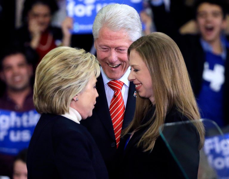 Democratic presidential candidate Hillary Clinton huddles with former President Bill Clinton and daughter Chelsea at her New Hampshire presidential primary campaign rally, Tuesday, Feb. 9, 2016, in Hooksett, N.H. (AP Photo/Elise Amendola)