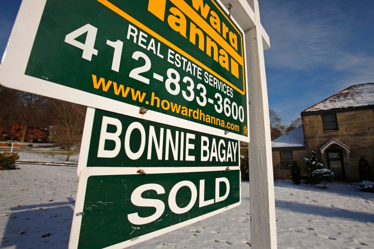In this Thursday, Jan. 9. 2014, photo, a sold sale sign hangs in front of a house in Mount Lebanon, Pa. The Commerce Department releases new home sales for January on Wednesday, Feb. 26, 2014. (AP Photo/Gene J. Puskar)