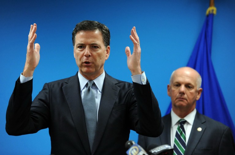In this photo from July 30, 2014, James Comey, Director of the Federal Bureau of Investigation, left, speaks to the media with U.S. attorney David J. Hickton at the FBI's Pittsburgh headquarters. Because of the Pittsburgh's cybersquad success, Comey said the FBI is rewarding the office with more manpower, allowing it to take on even more cyberthreats. (AP Photo/Post-Gazette-Michael Henninger)