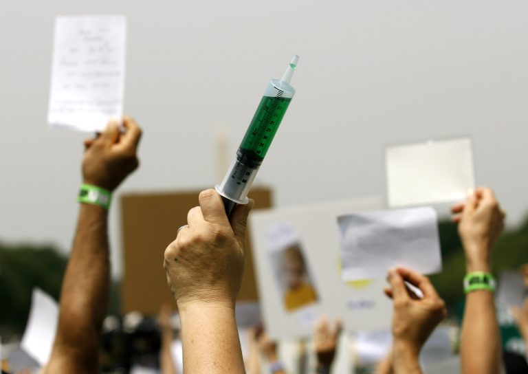 2008 file photo, a woman holds up a syringe with symbolic lightgreen fluid during a rally on Capitol Hill in Washington calling for the elimination of what demonstrators say are toxins in children's vaccines. Parents have been nervous about vaccines for as long as vaccines have been around. Opposition seemed to plummet for several decades, as vaccines got better and succeeded in beating back diseases, but parental concern has seemed to be on an upswing in the last 20 years. (AP Photo/Jose Luis Magana)