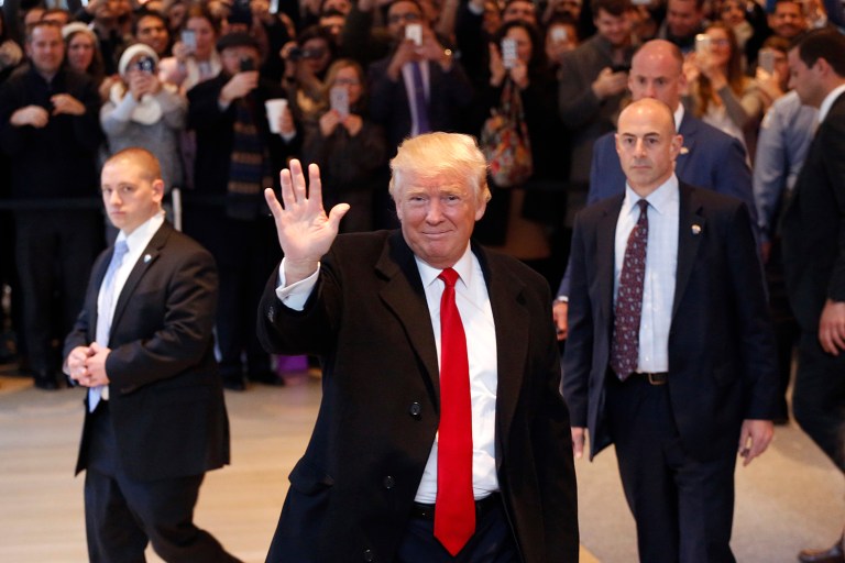 President-elect Trump waves to the crowd as he leaves the New York Times building following a meeting. Trump said Republican leaders 