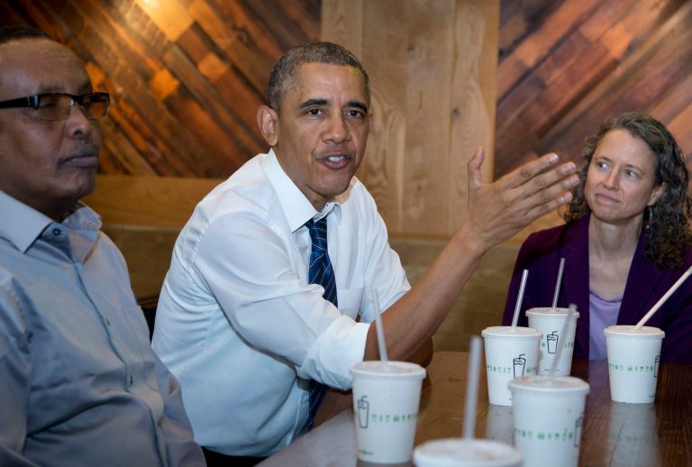 President Barack Obama flanked by Abdullahi Mohamed, left, and Meredith Upchurch speaks to reporters at a restaurant in Washington, Friday, May 16, 2014.  The president and Vice President Joe Biden met with construction workers involved in a recent infrastructure project.   (AP Photo/Manuel Balce Ceneta)