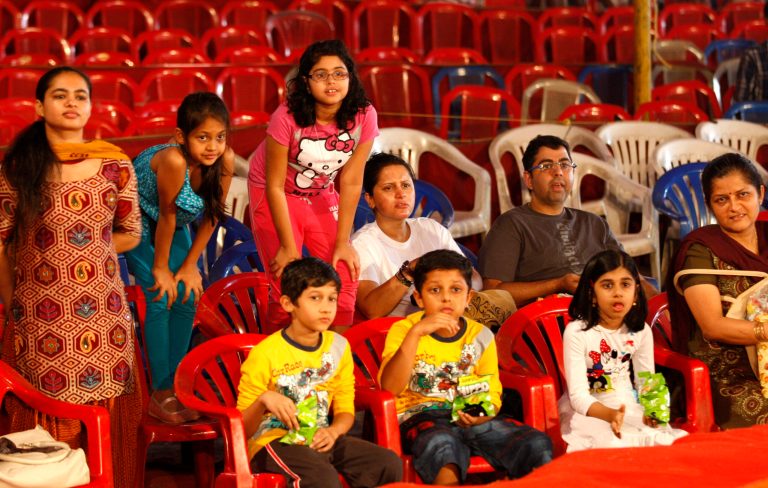 In this April 11, 2013 photo, Indian spectators watch a performance at the Rambo Circus on the outskirts of Mumbai, India. Circuses around the world may struggle to compete with an ever-increasing array of entertainment options, but India's once-widespread industry in particular has gone through cataclysmic changes. In the 1990s, there were 300 circuses operating throughout the country. That number has now dwindled to about 30, says circus manager John Matthew, and many of those are in financial trouble due to rising costs of renting field space, shrinking revenues and - crucially - two Supreme Court rulings that took away two of the industry's main attractions. (AP Photo/Rafiq Maqbool)