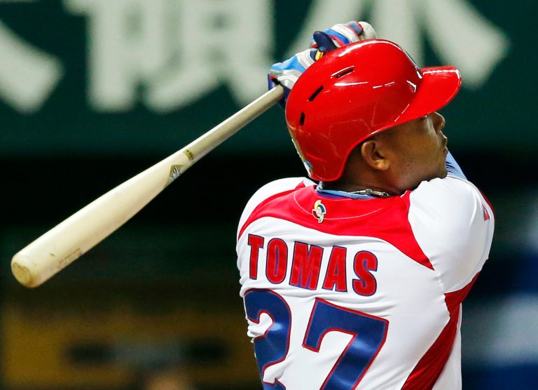 FILE - In this March 6, 2013 file photo, Cuba's Yasmani Tomas hits a solo shot off Japan's starter Kenji Otonari in the third inning of their World Baseball Classic first round game in Fukuoka, Japan. Cuban authorities said Friday, June 20, 2014, that the hard-hitting outfielder has defected. (AP Photo/Koji Sasahara, File)