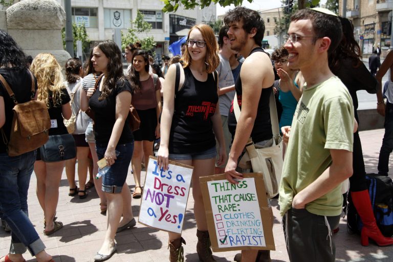 Israelis demonstrators hold up posters against sexual assault, as they march in an annual 
