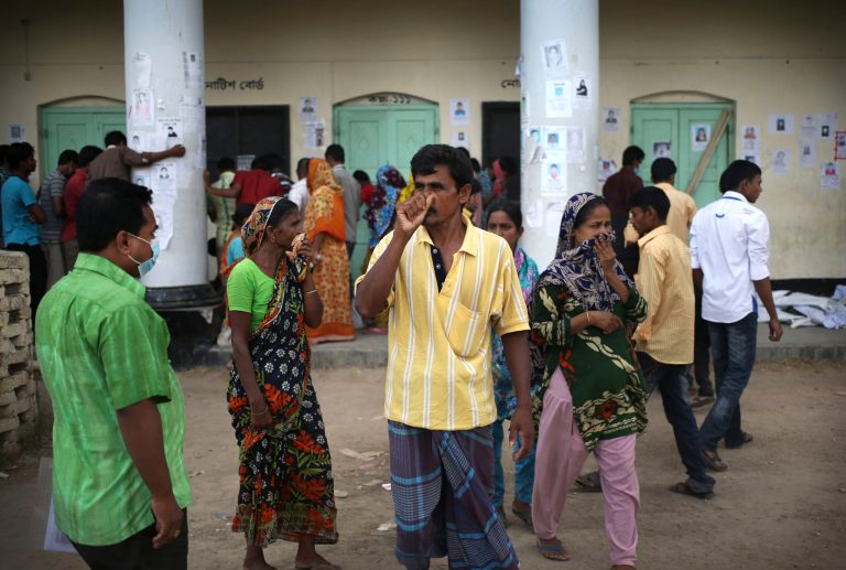 Onlookers and family members of missing garment workers gather to identify decomposing bodies pulled from the rubble of the collapsed garment factory building for identification Saturday, May 4, 2013 in Savar, near Dhaka, Bangladesh. The death toll in the accident rose to more than 530 on Saturday, a day after the country's finance minister downplayed the impact of the disaster on the garment industry, saying he didn't think it was 