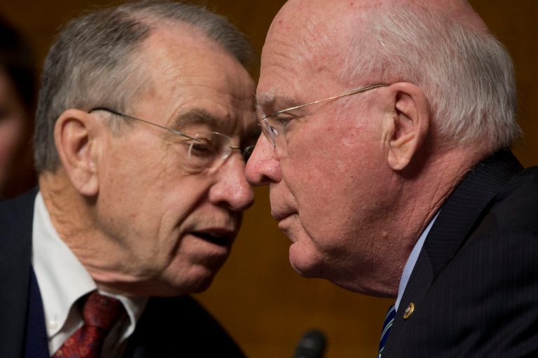 Senate Judiciary Committee Chairman Sen. Patrick Leahy, D-Vt., right, listens to the Committee Ranking Member Sen. Chuck Grassley, R-Iowa, on Capitol Hill in Washington, Tuesday, Feb. 4, 2014, during the committee's hearing on data breaches and combating cybercrime. (AP Photo/Pablo Martinez Monsivais)