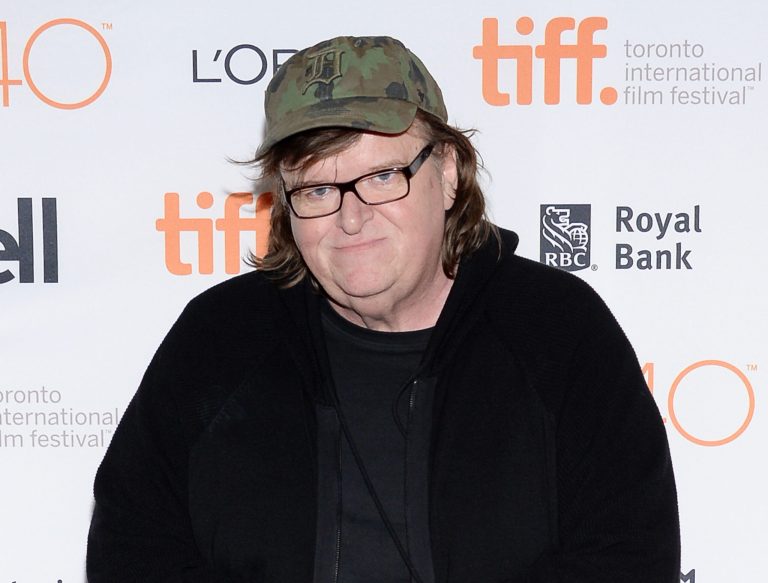 Liberal filmmaker Michael Moore said Tuesday that the reason why Democratic presidential candidate Hillary Clinton got embroiled in her email scandal was because years of attacks from Republicans have given her a mild case of posttraumatic stress disorder. (Photo by Evan Agostini/Invision/AP, File)