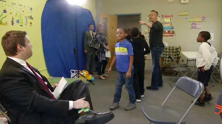 In this Monday, May 8, 2017, image made from a video by KCRG, U.S. Rep. Rod Blum walks out of a televised interview with reporter Josh Scheinblum, left, in front of a group of schoolchildren in Dubuque, Iowa, when pressed about screening attendees to his public meetings. (KCRG via AP)