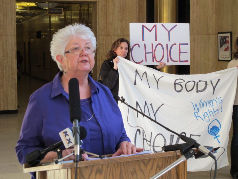 Dina Butcher speaks to a crowd of abortion-rights activists at the state Capitol in Bismarck, N.D., on Monday, March 25, 2013. More than 300 demonstrators attended the rally protesting a package of measures that would give the state the toughest abortion restrictions in the nation. (AP Photo/James MacPherson)
