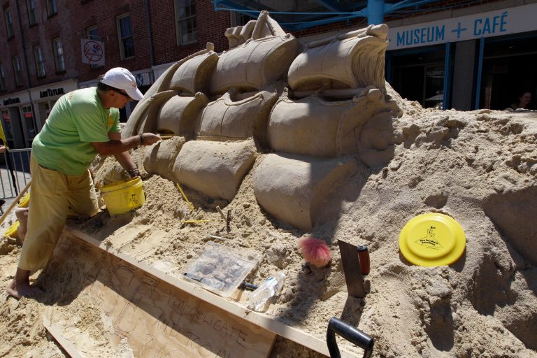   Master Sand Sculptor Matthew Long works on repairing a sand sculpture outside the South Street Seaport museum, Saturday, June 16, 2012 in New York. The sculpture was vandalized Friday night. (AP Photo/Mary Altaffer)  