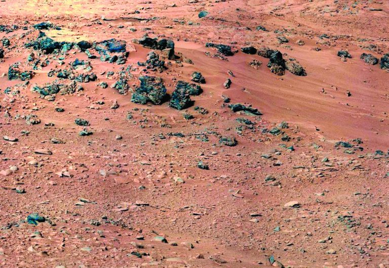 This handout image provided by NASA, taken Sept. 28, 2012, is a mosaic of images taken by the telephoto right-eye camera of the Mast Camera before the rover arrived at Rocknest. Mars Curiosity is about to sip its initial taste of the red planet's sand. But first, NASA's rover has to play bartender to make sure the dry dust is shaken, not stirred.The rover's scoop will dig into the sand Saturday. Then the action starts. Mission sampling chief Daniel Limonadi said the end of the rover's arm will shake vigorously and noisily for eight hours, like a Martian martini mixer gone mad. That will vibrate the fine dust grains through the rover chemical testing system to cleanse it of unwanted residual Earth grease. (AP Photo/NASA)