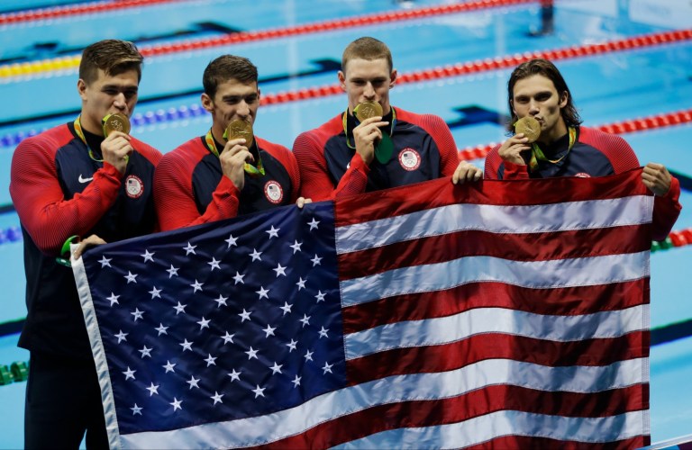 Under current law, victorious athletes owe taxes on both the prize money and the medals themselves. (AP Photo/Julio Cortez)