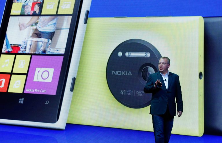 FILE - In this July 11, 2013 file photo, then Nokia CEO Stephen Elop desicribes the company's Nokia Lumia 1020, in New York. On Thursday, July 17, 2014, as part of an announcement to cut up to 18,000 jobs over the next year, Microsoft said it would discontinue its Nokia X phones and shift future product designs to its Lumia line of Windows phones. (AP Photo/Richard Drew, File)