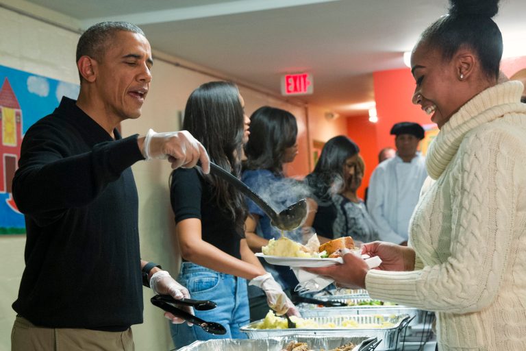 President Barack Obama serves Thanksgiving dinner during 