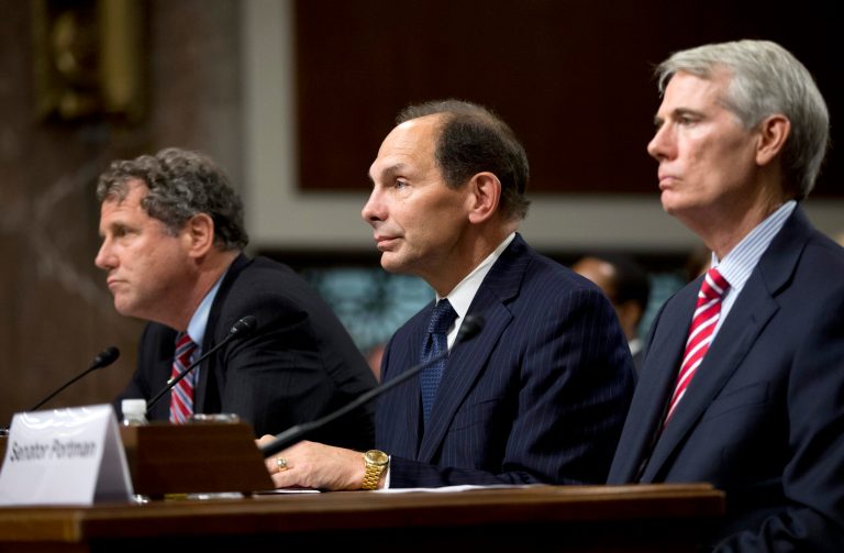Veterans Affairs Secretary nominee Robert McDonald of Ohio flanked by Sens. Sherrod Brown, D-Ohio, left, and Rob Portman, R-Ohio, right, listen during a Senate Veterans' Affairs Committee hearings to examine his nomination to be Secretary of Veterans Affairs on Capitol Hill in Washington, Tuesday, July 22, 2014.  (AP Photo)