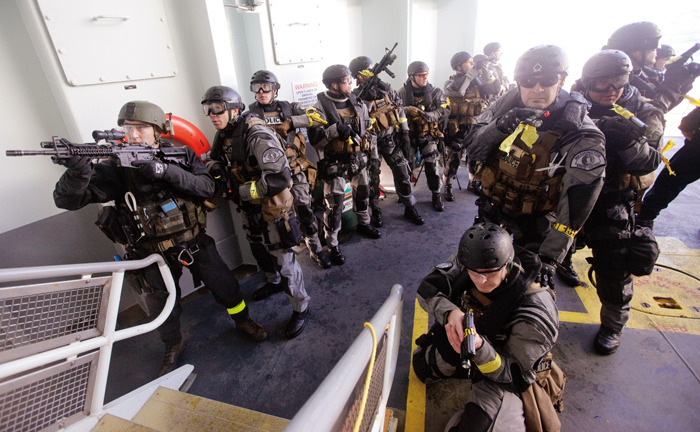 During a drill, SWAT team members prepare to clear the ship Monday, Oct. 29, 2012, moments after boarding the Washington State ferry M.V. Salish, out of Bainbridge Island, Wash. (AP Photo/Elaine Thompson)
