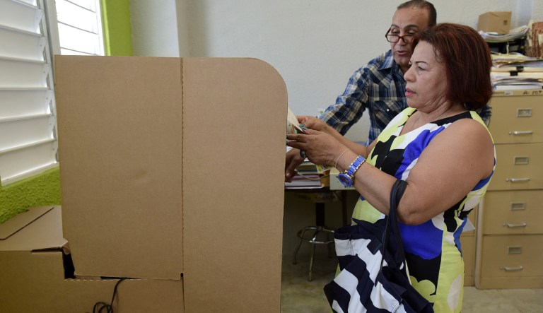 Puerto Rican resident Ciriaca Perez votes during the fifth referendum on the island's status, in San Juan, Puerto Rico, Sunday, June 11, 2017. Congress ultimately has to approve the outcome of Sunday's referendum that offers voters three choices: statehood, free association/independence or current territorial status. (AP Photo/Carlos Giusti)