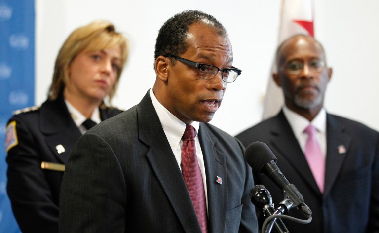   FILE - In this Dec. 16, 2010, file photo, Kenneth Ellerbe Washington then-Washington Mayor-Elect Vince Gray's nominee for Chief of Fire and Emergency Medical Services, center, talks as fellow nominees, Police Chief Cathy Lanier, left, and Deputy Mayor for Public Safety and Justice Paul A. Quander, Jr., listen during a news conference in Washington. Critics of the D.C. Fire and EMS department say it is struggling to keep up with the cityâs growing population and increasing number of emergency medical calls because it has too few paramedics. (AP Photo/Luis M. Alvarez, File)  