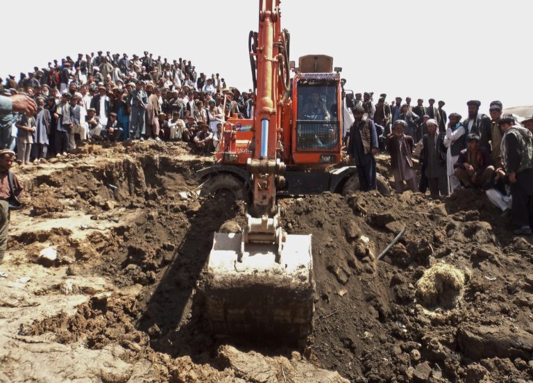 Afghans search for survivors after Friday's landslide buried Abi-Barik village in Badakhshan province, northeastern Afghanistan, Saturday, May 3, 2014. Afghan rescuers and hundreds of volunteers armed with shovels rushed on Saturday to help villagers hit by a massive landslide in the remote northeast a day earlier, officials said, while fears of a new torrent of mud and earth complicated rescue efforts. (AP Photo/Gulrahim Niazman)