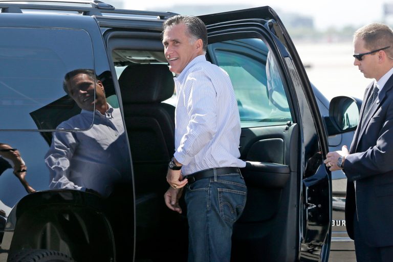 Mitt Romney gets in his vehicle as he arrives in Las Vegas Friday. (AP Photo)