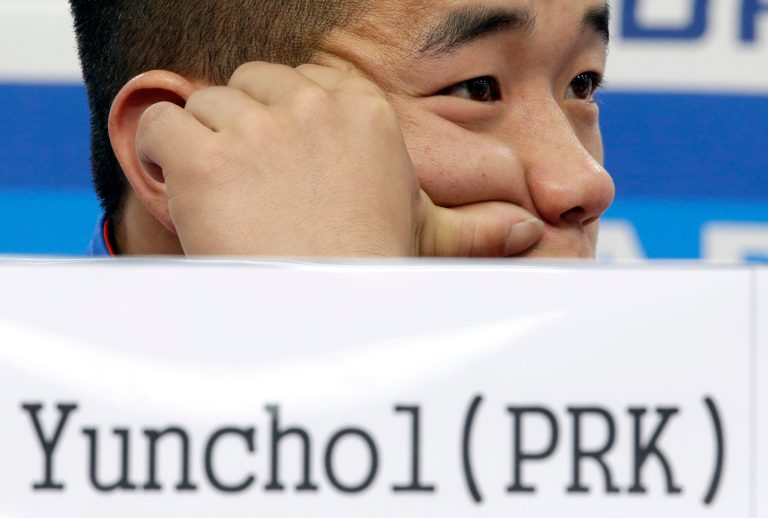 HOLD FOR USE WITH STORY BY ERIC TALMADGE, North Korea's gold medalist Om Yun Chol listens to reporter's question during a press conference at the 17th Asian Games in Incheon, South Korea, Tuesday, Sept. 23, 2014. (AP Photo/Lee Jin-man)