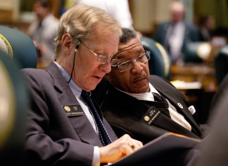 Rep. Pete Lee, D-Colorado Springs, left, Rep. Tony Exum, D- Colorado Springs confer as the Civil Unions Bill is debated in the House Chamber at the Capitol on Monday, March 11, 2013. The proposal got initial approval with a voice vote in the Democratic-controlled House on Monday. (AP Photo/Ed Andrieski)