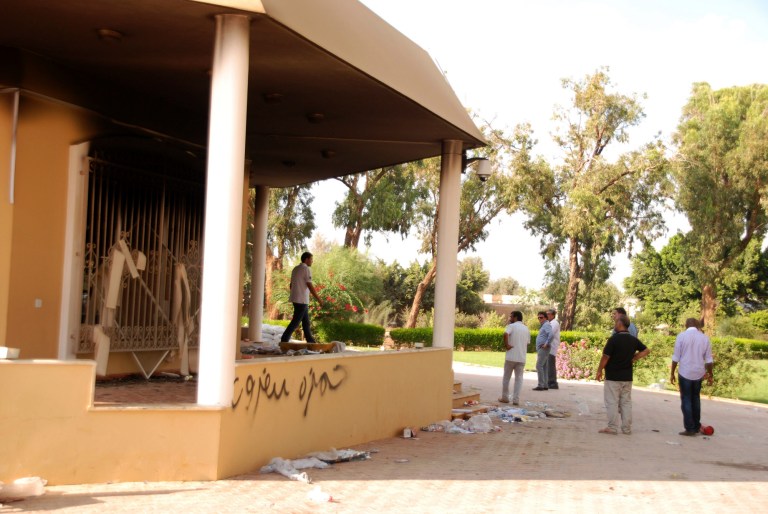 Libyans gather at the gutted U.S. consulate in Benghazi, Libya, after an attack that killed four Americans, including Ambassador Chris Stevens on Sept. 12, 2012. (AP/Ibrahim Alaguri)