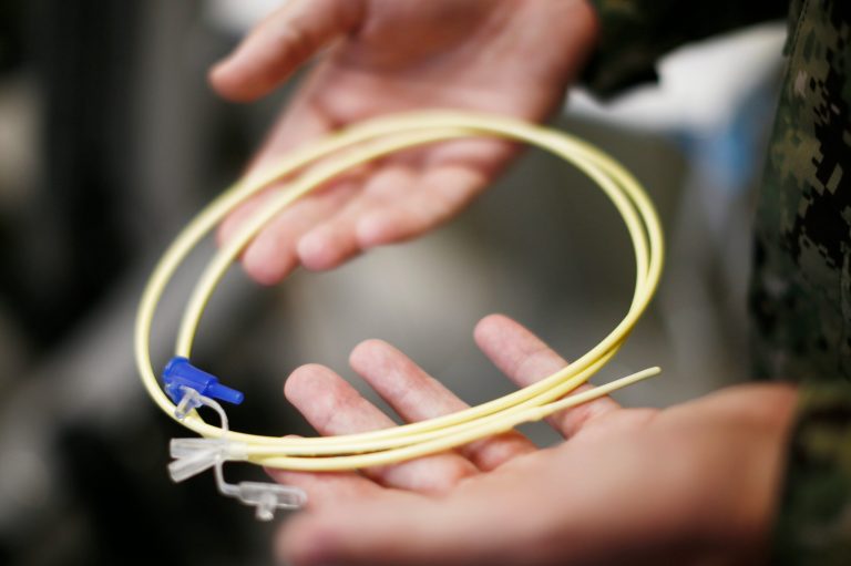 FILE - In this Nov. 20, 2013, file photo, reviewed by the U.S. military, U.S. Navy medical personnel displays an enteral feeding tube, used for force-feeding detainees, during a tour of the detainee hospital at Guantanamo Bay Naval Base, Cuba. The government is applying ill-advised procedures as a form of punishment for hunger strikers at Guantanamo Bay prison, a medical doctor told a federal court Tuesday, Oct. 7, 2014. The assessment by Dr. Steven Miles came at a hearing where lawyers for Abu Wa'el Dhiab are seeking to improve the conditions of confinement that Dhiab faces at the hands of his jailers. Lawyers for the Justice Department told the court that the military only feeds prisoners against their will to keep them alive and follows all laws when it does so. (AP Photo/Charles Dharapak,File)