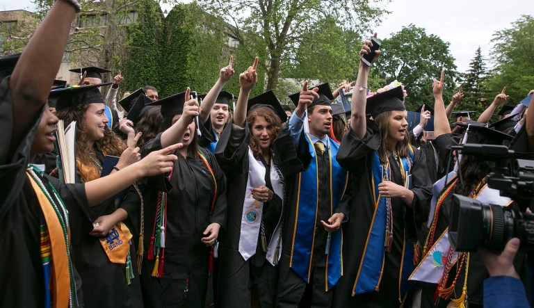 Notre Dame students walk out of the commencement ceremony in opposition opposed to the Trump administration's policies as Vice President Mike Pence is introduced at Notre Dame Stadium on Sunday, May 21, 2017, in South Bend, Ind. (Santiago Flores/South Bend Tribune via AP)