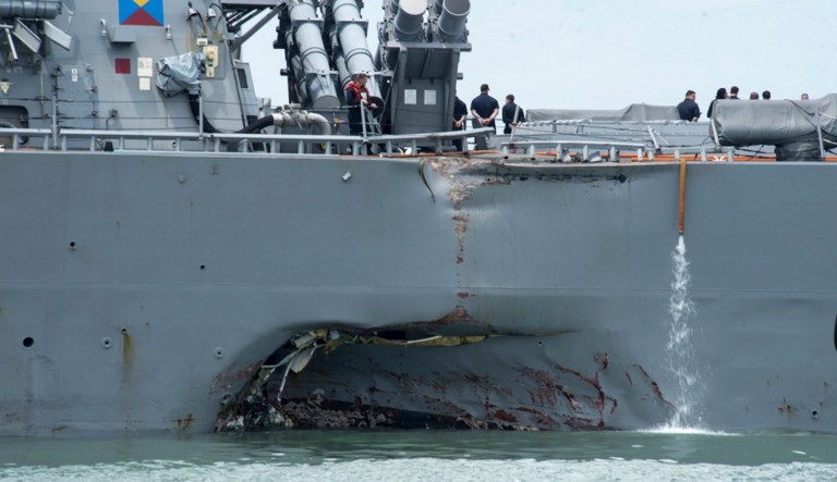 In this Aug. 21, 2017, file photo, damage is visible as the guided-missile destroyer USS John S. McCain steers towards Changi naval base in Singapore following a collision. Collisions in the Pacific last summer cost the lives of 17 sailors. (Mass Communication Specialist 2nd Class Joshua Fulton/U.S. Navy photo via AP, File)