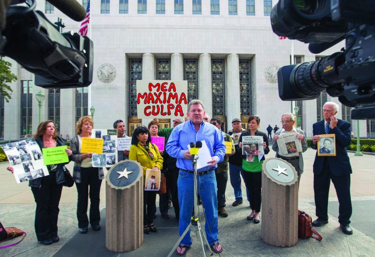 Patrick Wall, center at podium, a world-renowned expert on the Catholic Clergy Abuse Crisis joins members of SNAP, the Survivors Network of those Abused by Priests, during a news conference outside the US Attorney's office in Los Angeles, Wednesday, Feb. 6, 2013. Thousands of pages of confidential priest personnel files released by the Roman Catholic Archdiocese of Los Angeles last week are missing critical documents and contain redactions that overstep a judge's order, alleged victims of clergy abuse and their attorneys said Wednesday. (AP Photo/Damian Dovarganes)