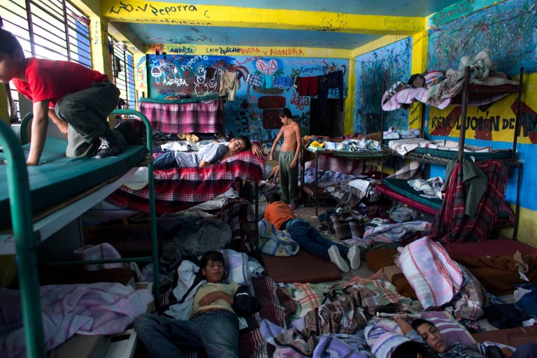 Boys watch television in their room at The Great Family group home, in Zamora, Mexico, Thursday, July 17, 2014. After a police raid on the refuse-strewn group home Tuesday, residents of the shelter told authorities that some employees beat residents, fed them rotting food or locked them in a tiny 