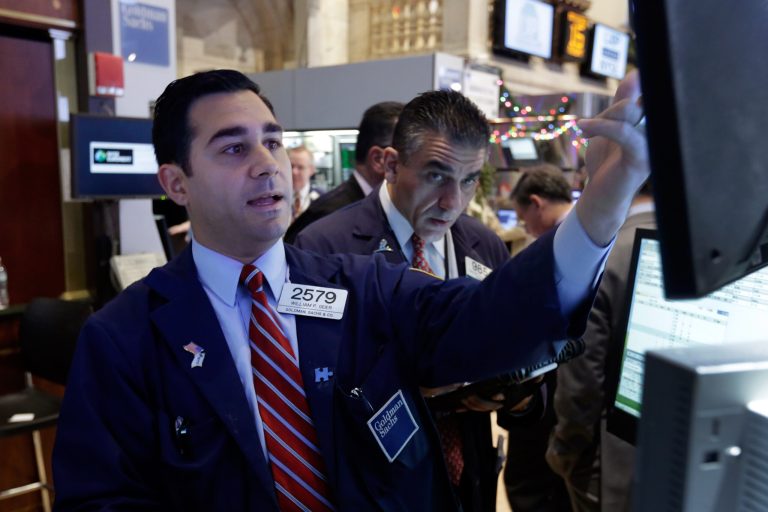 Specialist William Geier, left, works on the floor of the New York Stock Exchange. (AP/Richard Drew)
