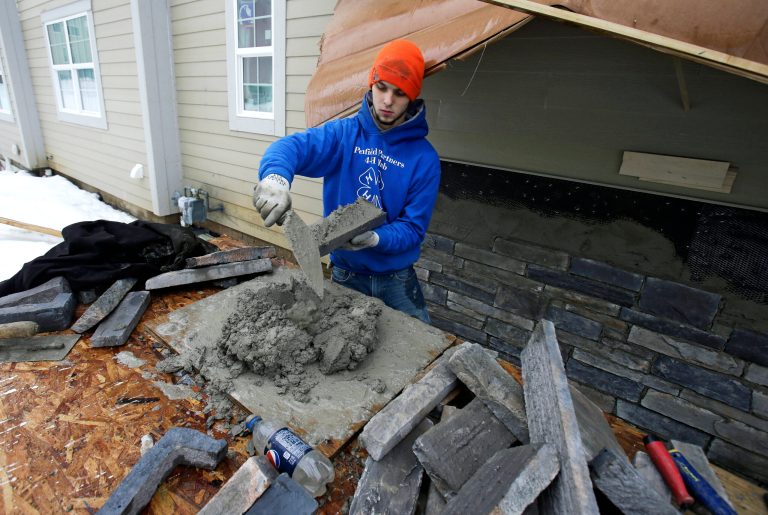 In this Jan. 10, 2014, photo, Trevor Davis puts concrete on stone for the foundation of a new home, in Pepper Pike, Ohio. The National Association of Home Builders reports on sentiment among U.S. builders on Tuesday, Feb. 18. (AP Photo/Tony Dejak)
