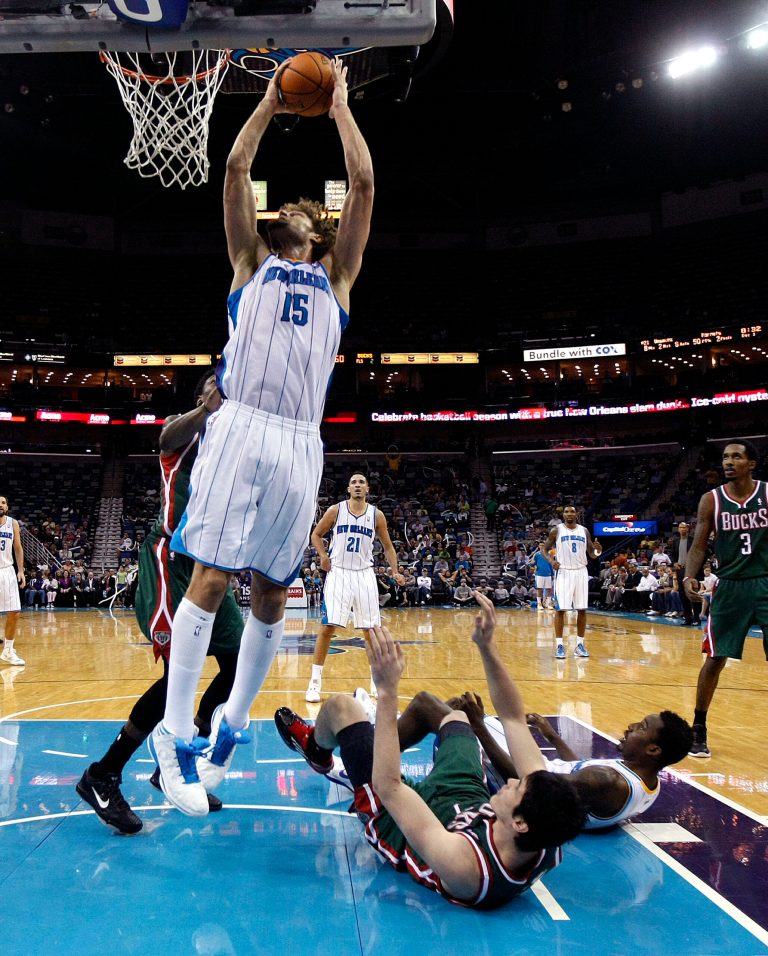   New Orleans Hornets center Robin Lopez (15) shoots as small forward Al-Farouq Aminu and Milwaukee Bucks small forward Ersan Ilyasova (7) fall to the floor in the second half of an NBA basketball game in New Orleans, Monday, Dec. 3, 2012. The Hornets won 102-81. (AP Photo/Gerald Herbert)  