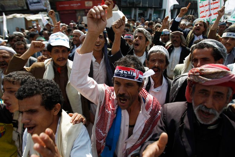 Yemeni Shiite groups chant slogans during an anti-government demonstration in Sanaa, Yemen, Monday, Aug. 18, 2014. Arabic writing on headband reads,