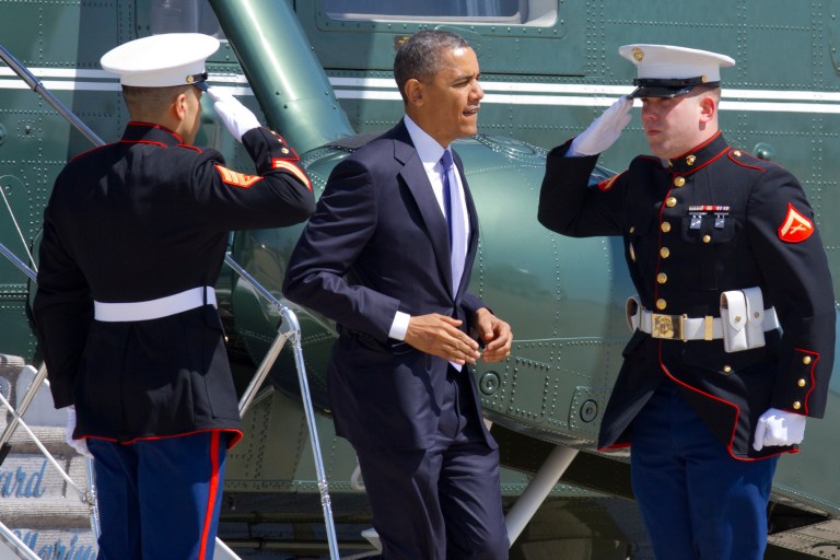 Marines salute as President Barack Obama jogs off of the Marine One helicopter before boarding Air Force One at Andrews Air Force Base, Md., Wednesday April 3, 2013, en route to Colorado. (AP Photo/Jacquelyn Martin)