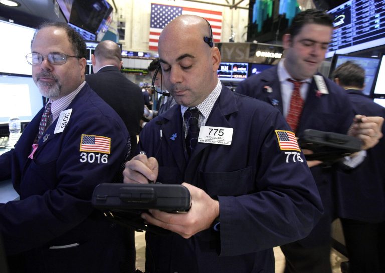   FILE- In this Thursday, Dec. 6, 2012, file photo, Trader Fred DeMarco, center works on the floor of the New York Stock Exchange. World stock markets swung higher Friday Dec. 14, 2012 after a survey showed an improvement in China's manufacturing, offsetting gloom from a sharp drop in Japanese business confidence. (AP Photo/Richard Drew, File)  