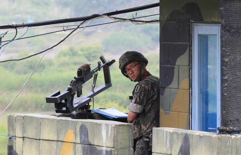 A South Korean army soldier stands guard at a military checkpoint near the border village of Panmunjom, which has separated the two Koreas since the Korean War, in Paju, South Korea, Saturday, June 7, 2014. North Korea has detained a 56-year old man from Ohio, accusing him of an unspecified crime after he traveled to the communist-led country as a tourist, the nation's state news agency and the man's family said Friday. (AP Photo/Ahn Young-joon)