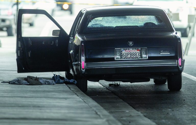 A vehicle riddle with bullet holes is part of a crime scene on Red Hills Ave. under the 5 Interstate in Tustin, Calif., Tuesday, Feb. 19, 2013. Police say a chaotic 25-minute shooting spree through Orange County left a trail of dead and injured victims before the shooter killed himself. There were multiple crime scenes in Tustin and Orange and many more victims who were shot at but unhurt, said Tustin Lt. Paul Garaven. Tustin is about 35 miles southeast of downtown Los Angeles. (AP Photo/Damian Dovarganes)