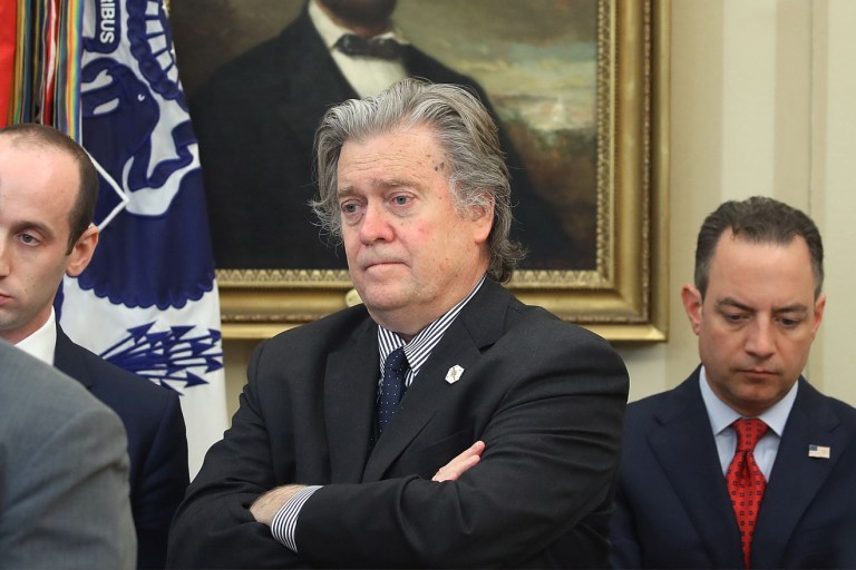 Then-presidential adviser Steve Bannon listens as Donald Trump speaks before signing an executive memorandum in the Oval Office, April 20.