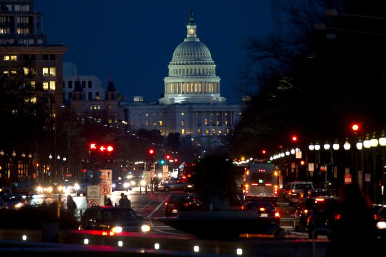   Red lights illuminate Pennsylvania Avenue as the U.S. Capitol glows in the twilight, in Washington, Wednesday, Dec. 19, 2012, as talks continue on the looming fiscal cliff. (AP Photo/Jacquelyn Martin)  