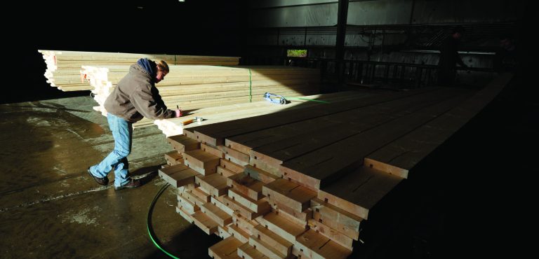 In this Friday, Dec. 21, 2012 photo, Erin Hall marks a load of wood trim at Belco Forest Products in Shelton, Wash. Hall was hired after an audit by the U.S. Immigration and Customs Enforcement Department resulted in the layoff of more than 20 workers for having suspect documents authorizing them to work in the United States. (AP Photo/Ted S. Warren)