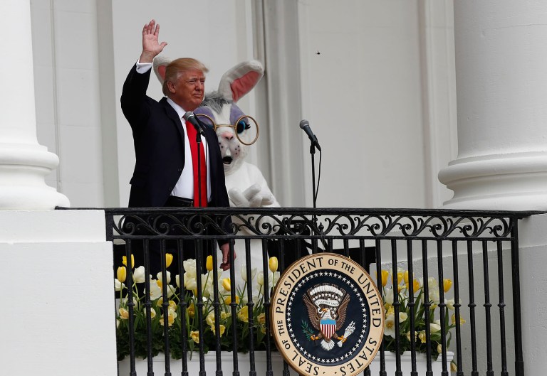 President Donald Trump accompanied by the Eastern bunny, waves from the Truman Balcony of the White House in Washington, Monday, April, 17, 2017 during the annual White House Easter Egg Roll. (AP Photo/Carolyn Kaster)
