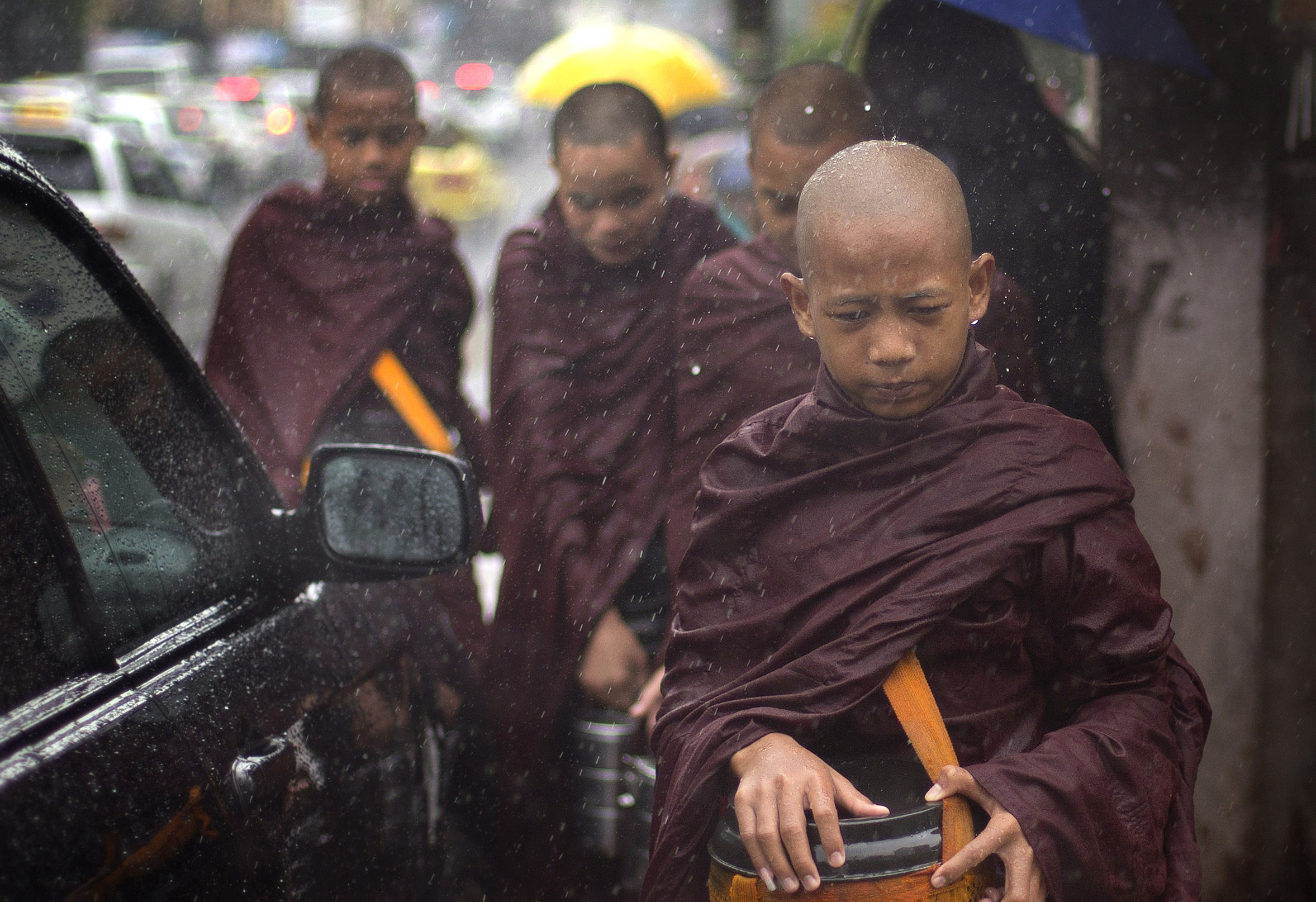Image of Asia: Collecting alms in the rain