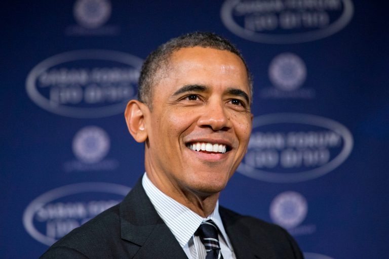 President Barack Obama smiles as he arrives at the  Saban Forum to speak about the Middle East at the Willard Hotel in Washington, Saturday, Dec. 7, 2013. The 2013 Forum is examining the political changes taking place across the Middle East, and the President spoke about topics including Iran. (AP Photo/Jacquelyn Martin)