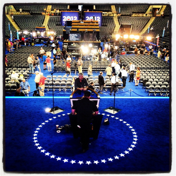 Workers make preperations on the stage before the start of the Democratic National Convention at Time Warner Cable Arena. Many Democratic lawmakers are skipping the convention. (Getty Images)